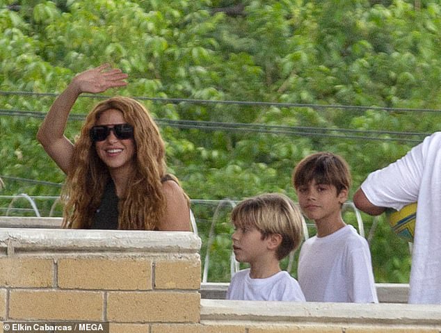 Hello!  The singer was joined by sons Milan, nine (L) and Sasha, seven (C) and waved to the huge crowd of waiting fans