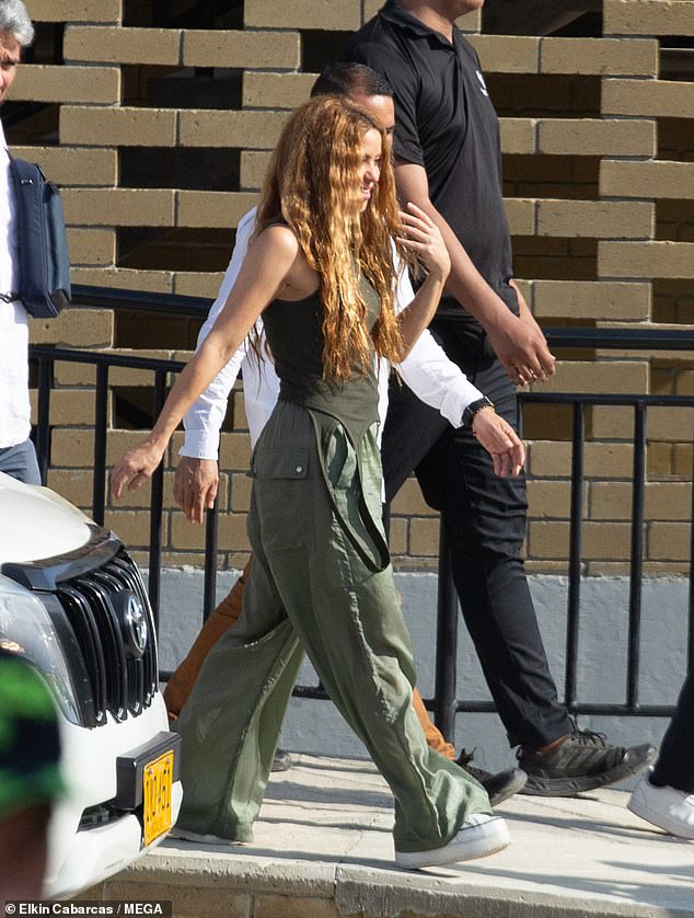 Style: Shakira, who shares her children with ex Gerard Pique, cuts a trendy figure in a tight green cardigan and wide cargo pants