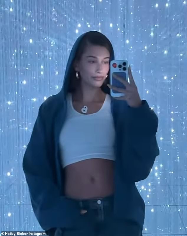 Beauty in blue: The skilled print campaign model exuded '90s vibes in an oversized blue hoodie, white cropped tank and blue jeans