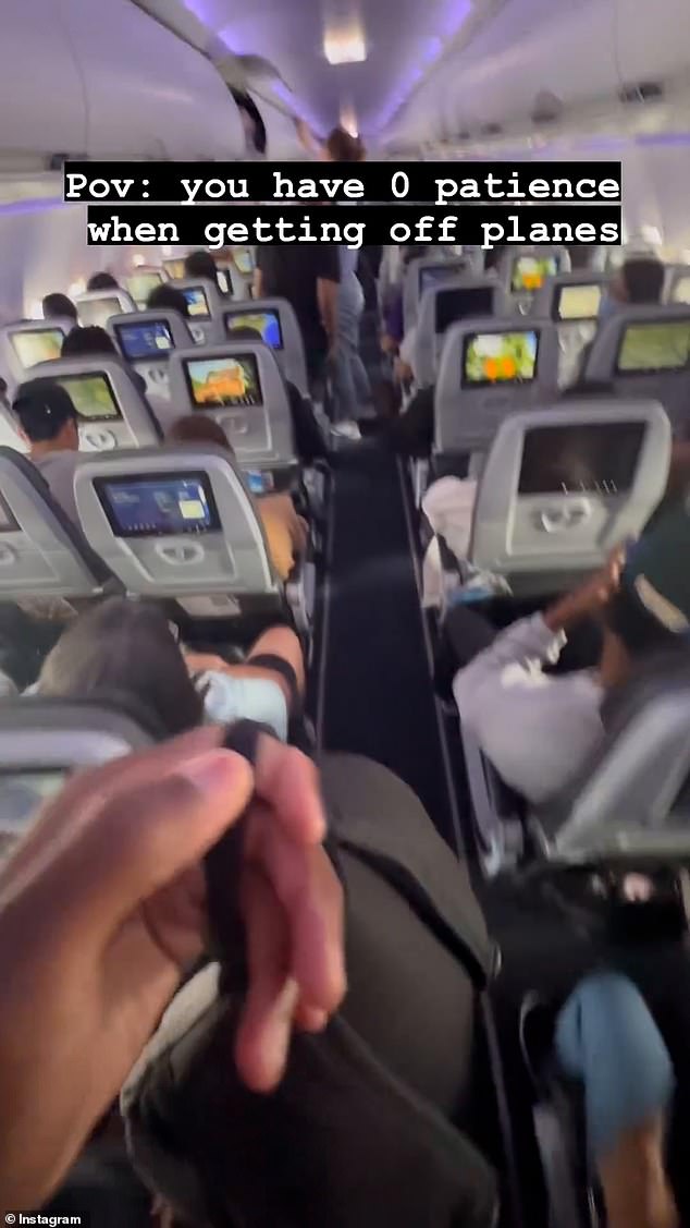 The man was sitting in the back row and quickly stood up as soon as the seat belt sign went off.  He found his way to the front of the plane within seconds