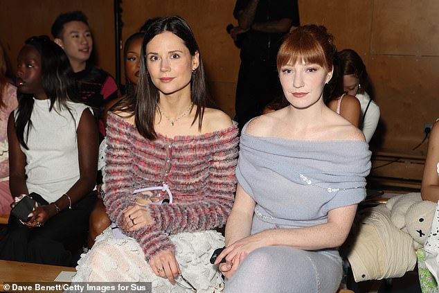 Gorgeous: Nicola (R) tied up her glossy red locks and carried a crystal-embellished handbag that made a statement (pictured with radio host Lilah Parsons, L)