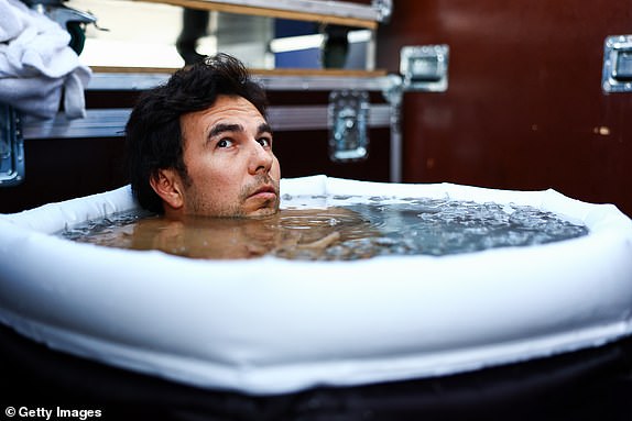 SINGAPORE, SINGAPORE – SEPTEMBER 17: Sergio Perez of Mexico and Oracle Red Bull Racing take an ice bath ahead of the F1 Grand Prix of Singapore at Marina Bay Street Circuit on September 17, 2023 in Singapore, Singapore.  (Photo by Mark Thompson/Getty Images)