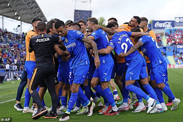 Greenwood (centre left) joins his team's celebrations after they scored an 86th minute winner