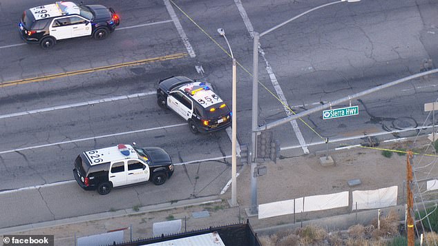 Aerial footage showed police lining up along the Sierra Highway in Palmdale, California, near where the killing took place