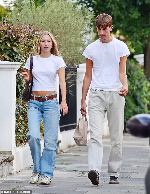 Stylish: Yoni wore a matching white T-shirt and completed the look with beige pants and black sneakers