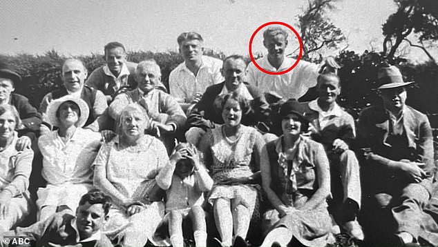 In an old family photo album, Charles Webb is seen in the back row of a family photo, playfully placing his hand on the head of a man believed to be his brother-in-law (Charles Webb is circled in red)