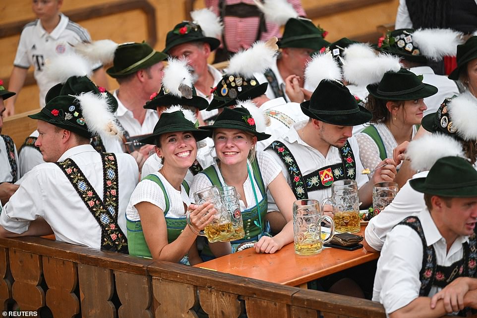 Revelers dressed in traditional lederhosen and 'dirndls' descend on Munich for the 188th Oktoberfest