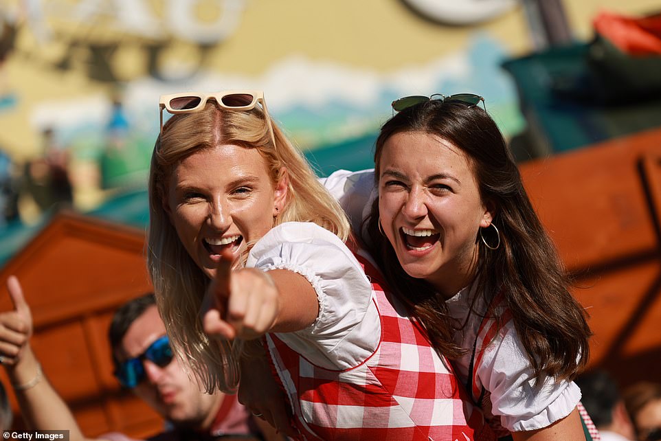 Revelers enjoy the sunny and warm weather on the opening day of the festival