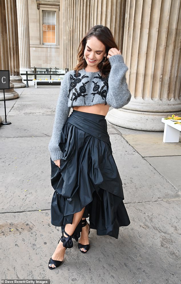 Stylish: Lily showed off her washboard abs in the cropped sweatshirt and smiled for the cameras at the star-studded event