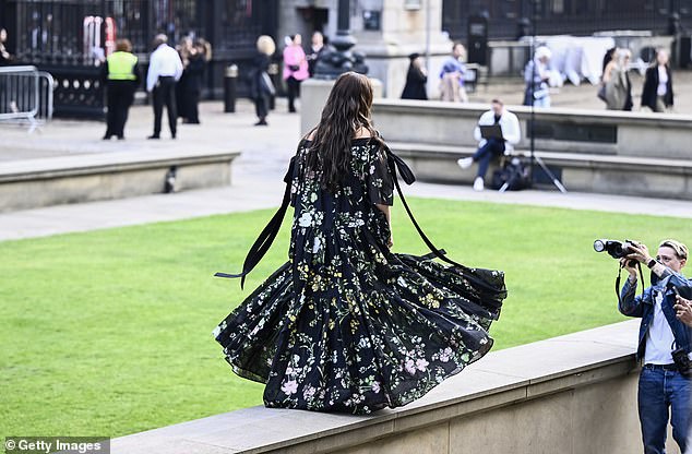 Star of the show: The model showed off her toned shoulders and twirled for the cameras before heading to the fashion show