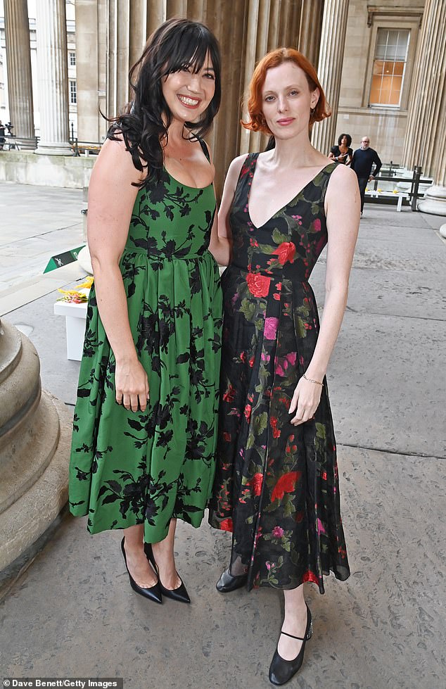 Stunning: She stole the show in the corset-style dress that cinched around her waist to show off her petite figure (pictured with Karen Elson)