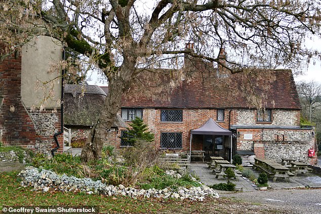 The 15th century former coaching inn features a pub garden, outdoor seating area, parking, detached barn, stable block, two-bedroom cottage and garage