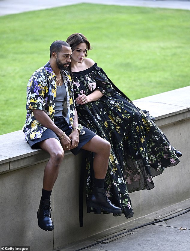 In love: she was accompanied by her husband Justin Ervin, who opted for a floral shirt and shorts, which he paired with motorcycle boots