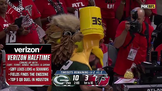 The nickname “cheesehead” became quite literal for this fan as sauce was poured on him