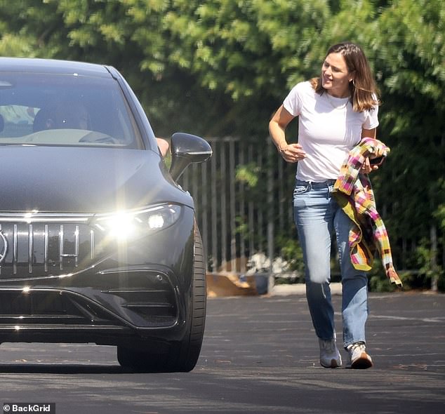 One last smile: She turned and smiled at the Gone Girl star before getting into her car