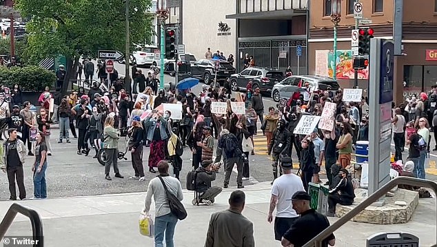 A crowd continued to build outside the Hilton San Francisco in the city's financial district, while conference attendees were barricaded inside for their safety.