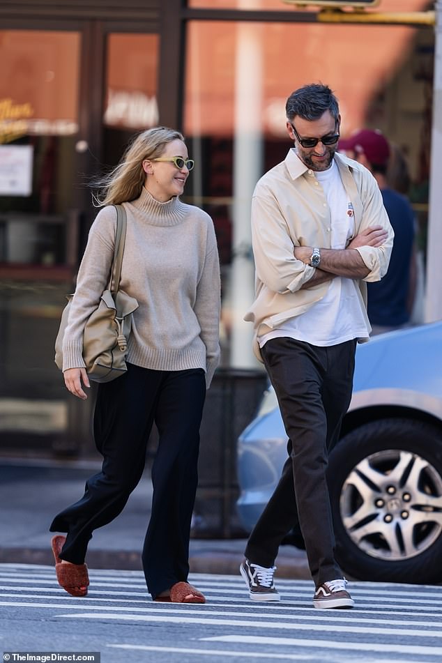 Casual cool: Meanwhile, her husband, 39, kept it casual in a white T-shirt, a light yellow long-sleeved shirt and dark brown pants