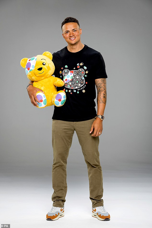 Looking good: The One Show's Jermaine Jenas rocked a black T-shirt and cuddled with the charity's famous mascot