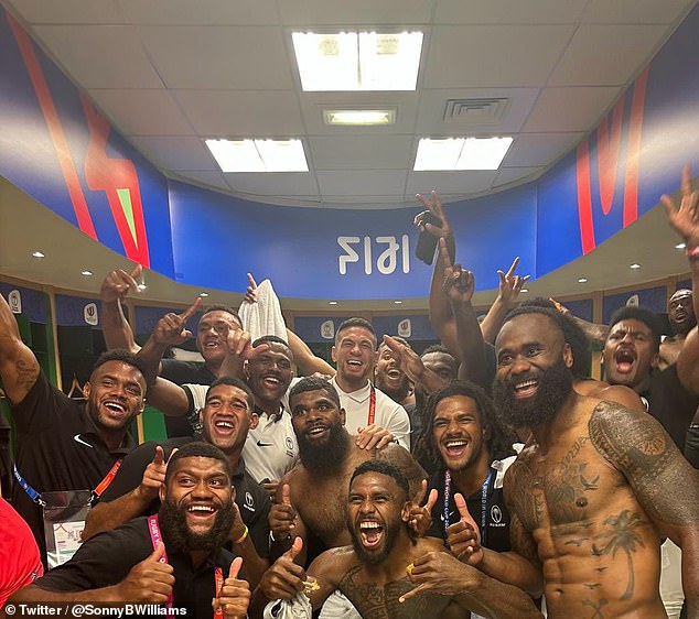 Williams and the Fijian players including former NRL superstar Semi Radradra (right) celebrate the historic victory over Australia