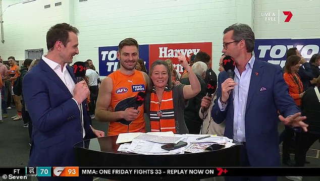 Mel Bedford goes for round two, crashing into Channel 7's desk and getting a sneaky hug from star Giants midfielder Stephen Coniglio