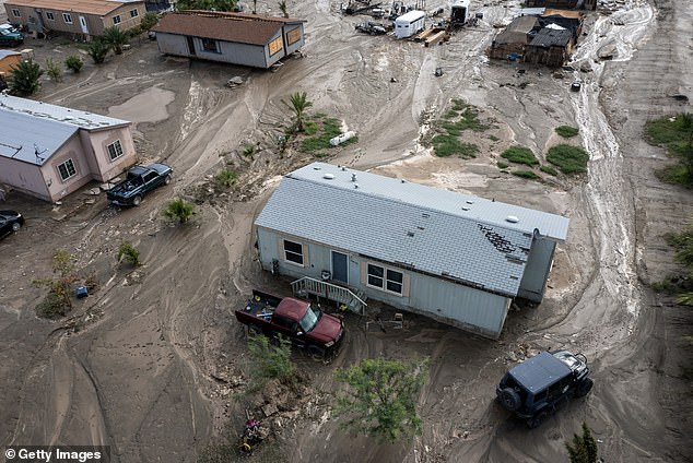 In an aerial view, mud surrounds homes damaged by a flash flood caused by a monsoon thunderstorm that quickly dropped four inches of rain in a region still recovering from Tropical Storm Hilary on September 2, 2023 in Thermal, California