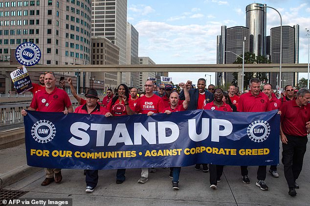 Members of the UAW union march through the streets of downtown Detroit after a rally on the first day of the UAW strike in Detroit