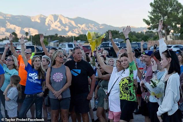 Mourners are seen joining Probst's family at the site where he was killed in Northwest Vegas