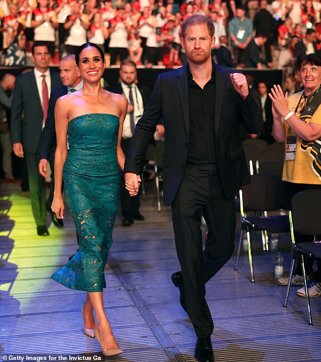 The Duchess of Sussex and Prince Harry looked elegant and cheerful as they attended the closing ceremony of the sixth Invictus Games in Germany