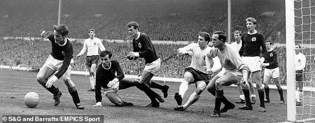 McKinnon (second from left) helps to crowd Geoff Hurst during Scotland's famous victory over world champions England in 1967 at Wembley