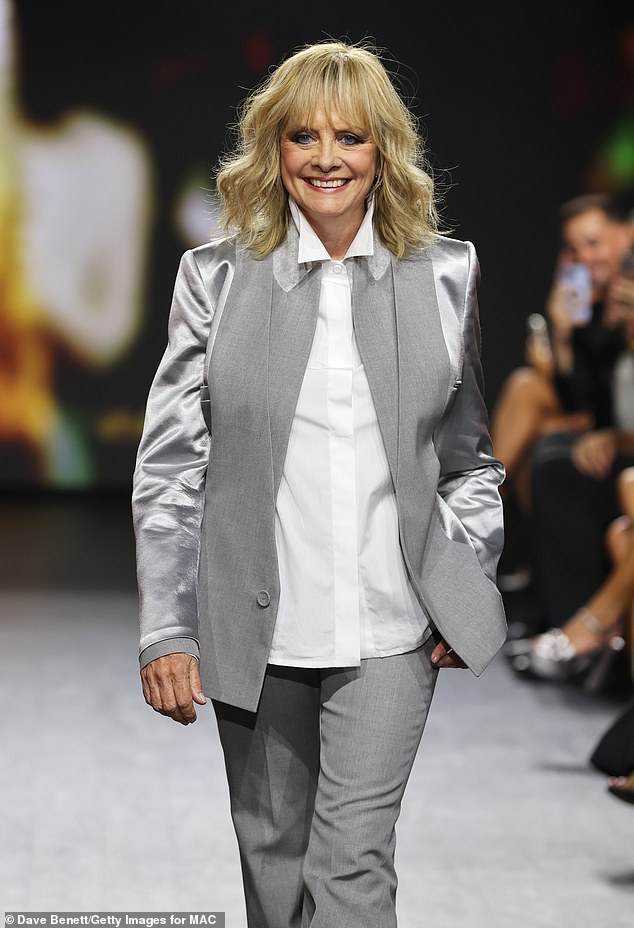 Style: The iconic model exuded sophistication in a chic silver suit with satin sleeves and wide-leg trousers.