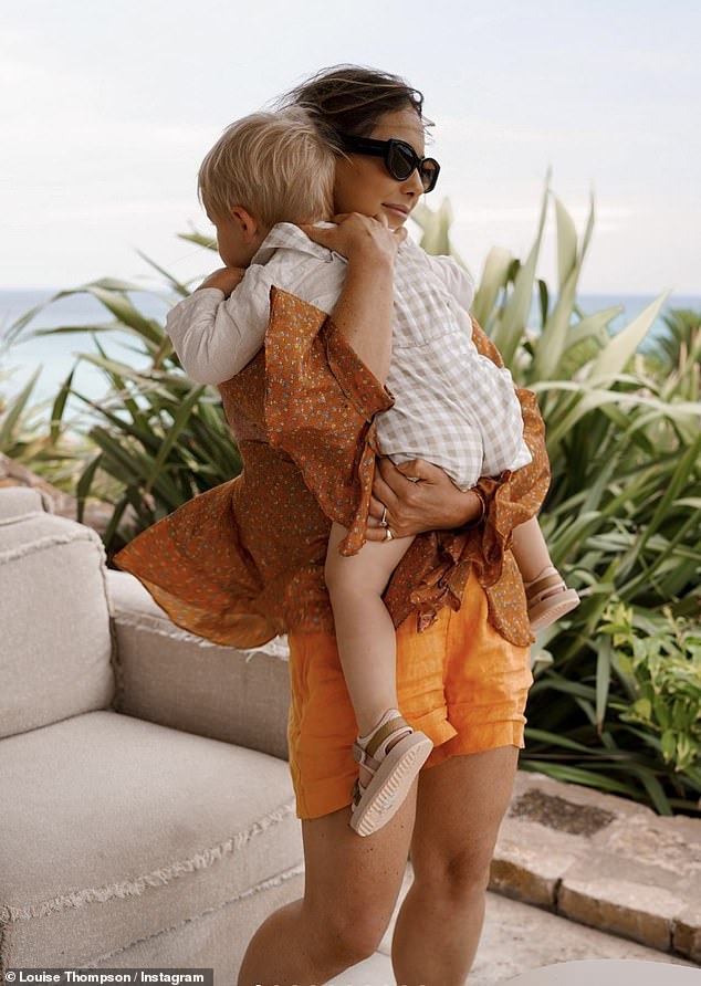 Hugs: The MIC star wrapped her arms around her son as he was dressed in orange