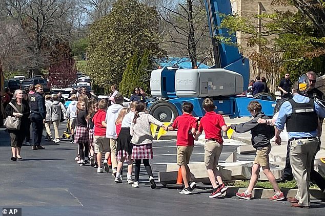 Children hold hands as they leave Covenant School in Nashville, Tennessee, after the deadliest school shooting of 2023