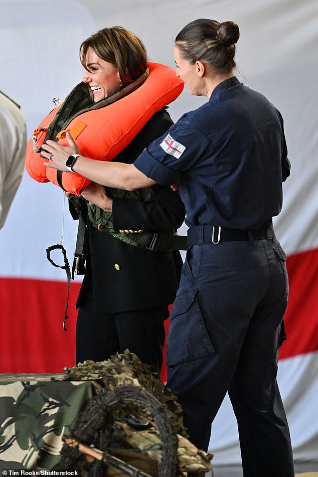 A staff member came to the princess's aid with the inflated life jacket to help her remove it