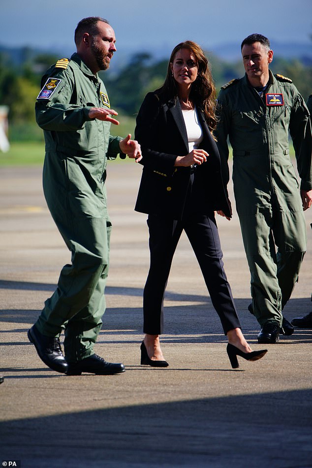 Princess Kate, mother of three, wore navy blue block heels to match her elegant outfit, with the blazer layered over a white top