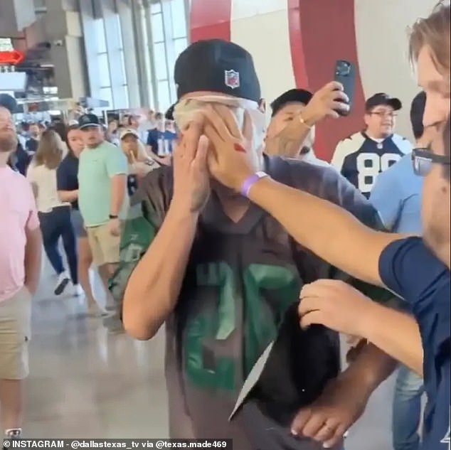 A third Jets fan — not yet captured in the video — was seen with napkins covering his face