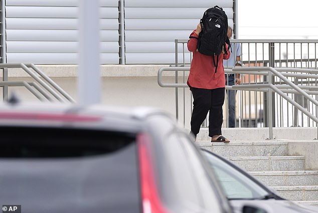 A relative of one of the five Israelis covered her face with a bag as she left the Famagusta District Courthouse building in Paralimni, Cyprus last week.