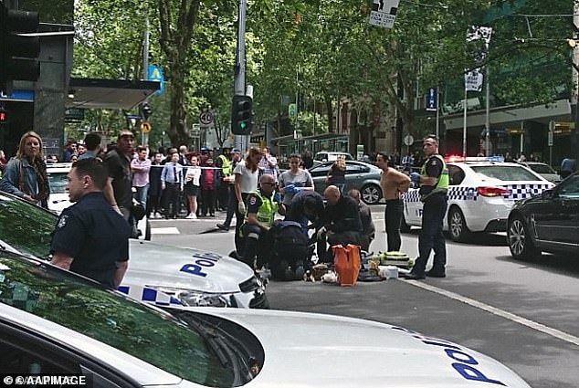 Hassan Khalif Shire Ali stabbed three people before being shot dead by police.  The photo shows one of the victims being treated by paramedics