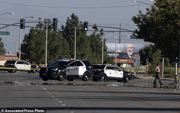 Police cars block a street where a deputy was shot while sitting in his patrol car in Palmdale, California on Sunday, September 17, 2023. (AP Photo/Richard Vogel)