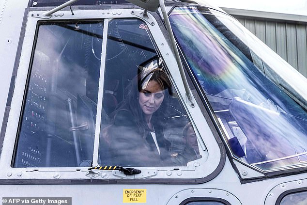 The princess is depicted sitting in the cockpit of the Merlin Mk II helicopter