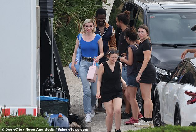 Smile: Sophie looked cheerful as she chatted with cast and crew members - as estranged husband Joe goes on tour with his band - Jonas Brothers