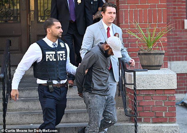 De Ventura's neighbor Carlisto Acevedo Brito, 41, (pictured) kept his head down as he left NYC's 52nd precinct after also being arrested in connection with the overdose