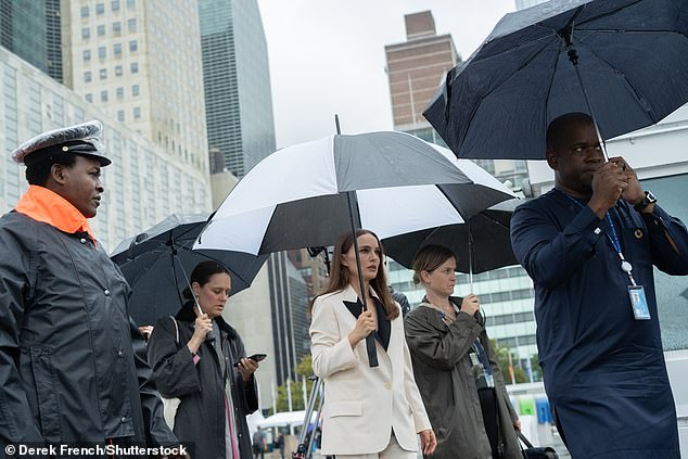 Stepping out in the rain: She was then seen walking out into the rain with an umbrella over her head after the first day of the 78th session of the United Nations General Assembly at the United Nations Headquarters in New York City