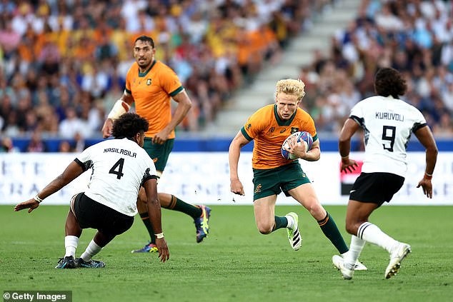 Carter Gordon (pictured with the ball against Fiji) was roundly criticized for his poor display in the defeat - but his coach defended the fly-half despite benching him