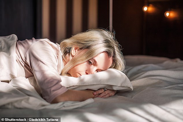 Simply sitting by a window isn't enough when it comes to becoming 'more of a lark' and sleeping earlier - and neither is turning on the light (stock photo)