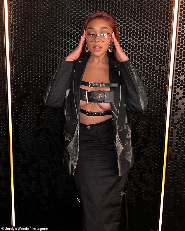 Daring: The 25-year-old social media star looked effortlessly cool in an all-black look with an edgy crop top made of straps that covered her chest