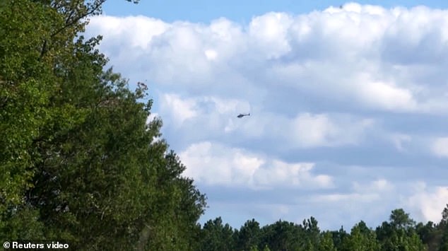 A helicopter is photographed on Monday during the search for the wreckage