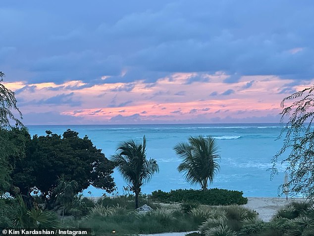 Breathtaking views: The beauty lay on a large towel by a sparkling pool, which also included breathtaking ocean views and a colorful sunset