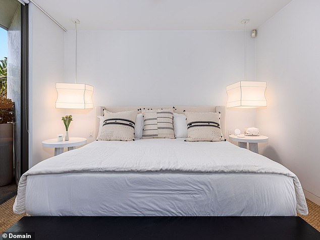 The master bedroom features an ensuite bathroom with Minerva limestone, built-in wardrobes and Juliet balconies