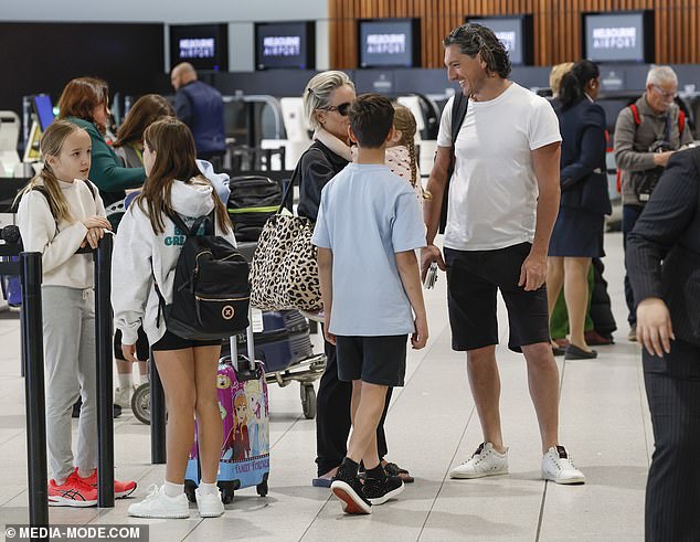 Rocky looked every inch a handsome dad, wearing a white T-shirt and black shorts.  He completed his look with a pair of white sneakers