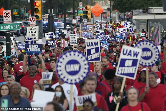 Members of the United Auto Workers march through downtown Detroit on Friday.  The UAW carries out a strike against Ford, Stellantis and General Motors